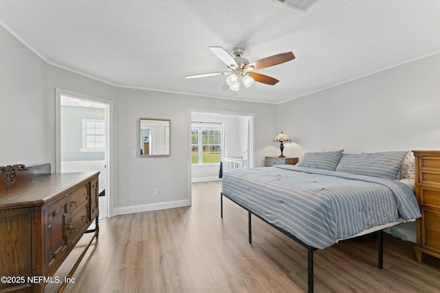 12531 County Road 121, Bryceville, FL 32009 - bedroom featuring baseboards, light wood finished floors, a textured ceiling, and crown molding