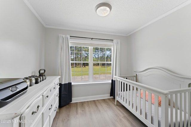 12531 County Road 121, Bryceville, FL 32009 - bedroom featuring crown molding, baseboards, light wood-style floors, and a textured ceiling