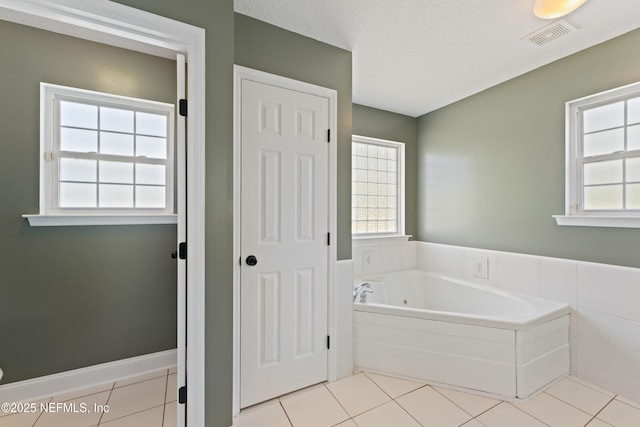 12531 County Road 121, Bryceville, FL 32009 - bathroom with tile patterned floors, a bath, a textured ceiling, and visible vents