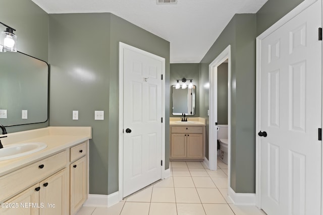 12531 County Road 121, Bryceville, FL 32009 - full bath with two vanities, tile patterned flooring, toilet, visible vents, and a sink