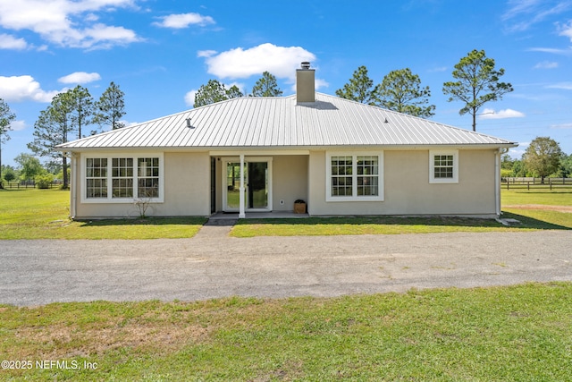 12531 County Road 121, Bryceville, FL 32009 - view of front of home featuring a front yard, metal roof, stucco siding, and a chimney