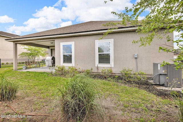 rear view of property with a patio area, fence, a yard, and cooling unit