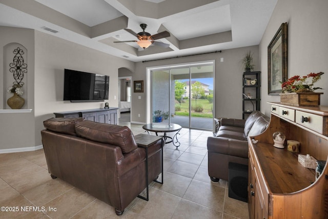 living area with light tile patterned flooring, ceiling fan, visible vents, and coffered ceiling