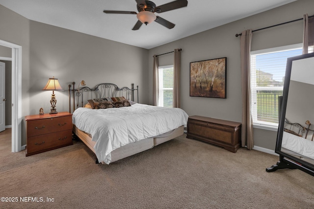 bedroom featuring a ceiling fan, baseboards, and light carpet