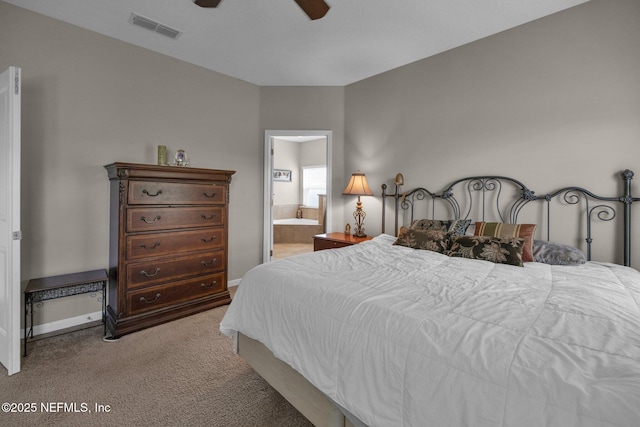 bedroom with visible vents, connected bathroom, baseboards, and carpet floors