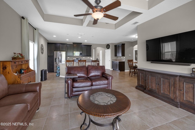 living area featuring visible vents, recessed lighting, arched walkways, a ceiling fan, and light tile patterned floors