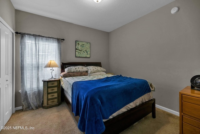 carpeted bedroom featuring baseboards