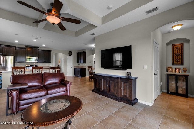 living area with recessed lighting, arched walkways, a ceiling fan, and light tile patterned floors
