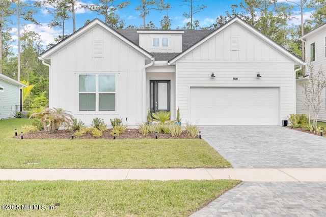 145 Bridgeton St, Saint Johns, FL 32259 - modern farmhouse style home with board and batten siding, decorative driveway, a front lawn, an attached garage, and a shingled roof