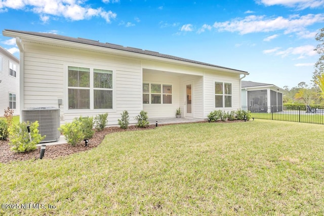 145 Bridgeton St, Saint Johns, FL 32259 - rear view of property featuring a sunroom, a yard, fence, and central AC unit