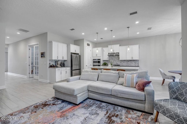 145 Bridgeton St, Saint Johns, FL 32259 - living room with visible vents, baseboards, recessed lighting, and light wood-style floors
