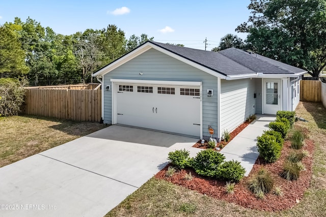 ranch-style house with fence, roof with shingles, driveway, and an attached garage