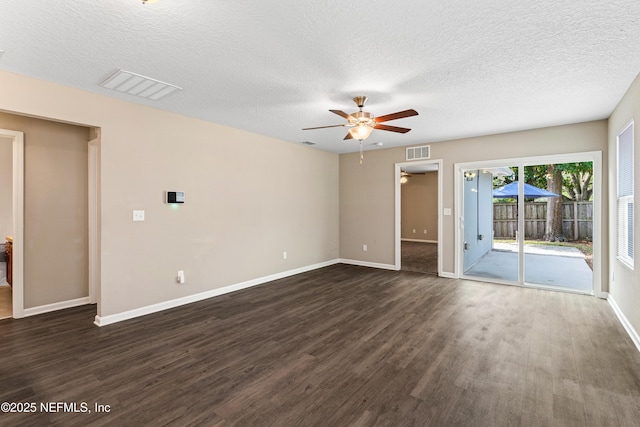 unfurnished room with baseboards, visible vents, ceiling fan, and dark wood-type flooring