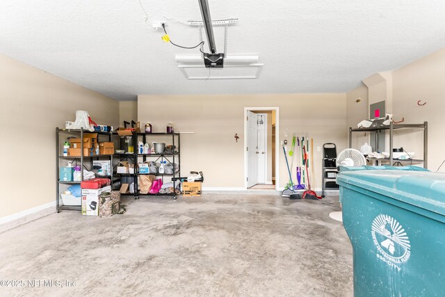 garage with a garage door opener and baseboards
