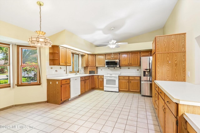 kitchen featuring a sink, light countertops, lofted ceiling, and stainless steel appliances