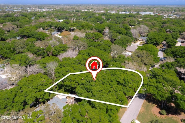 aerial view featuring a wooded view