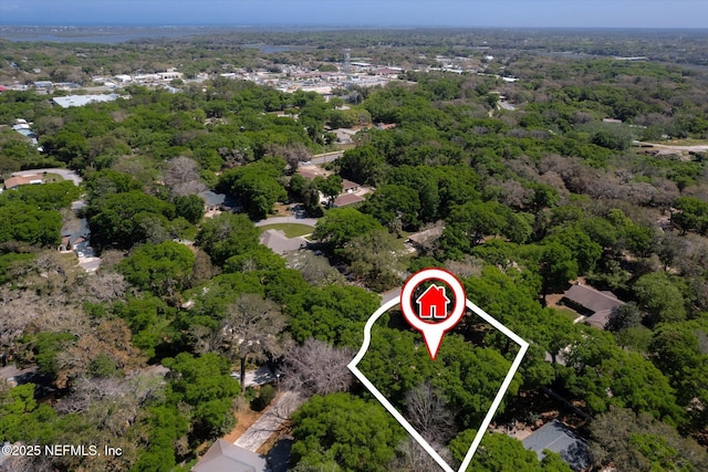 birds eye view of property with a forest view