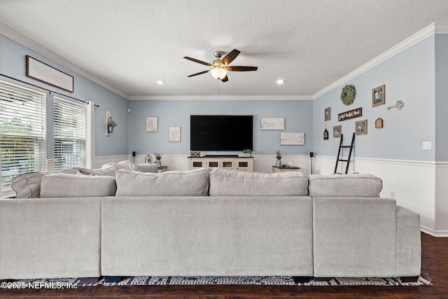 112 Bluffton Ct, Saint Augustine, FL 32092 - living area with a ceiling fan, dark wood-type flooring, crown molding, wainscoting, and a textured ceiling