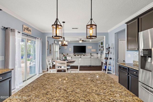 112 Bluffton Ct, Saint Augustine, FL 32092 - kitchen with stainless steel fridge, light tile patterned flooring, visible vents, stone countertops, and ornamental molding
