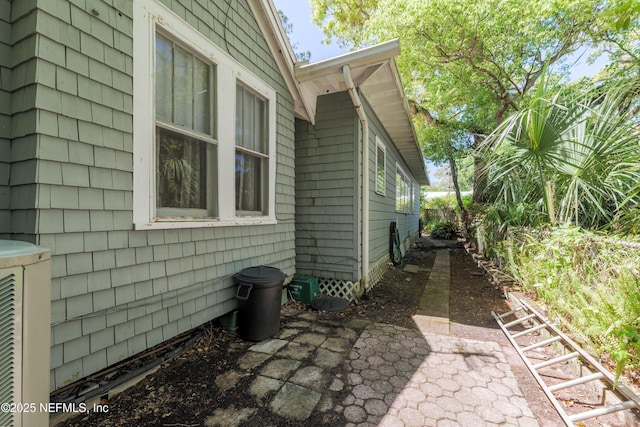 view of side of home featuring a patio area and fence