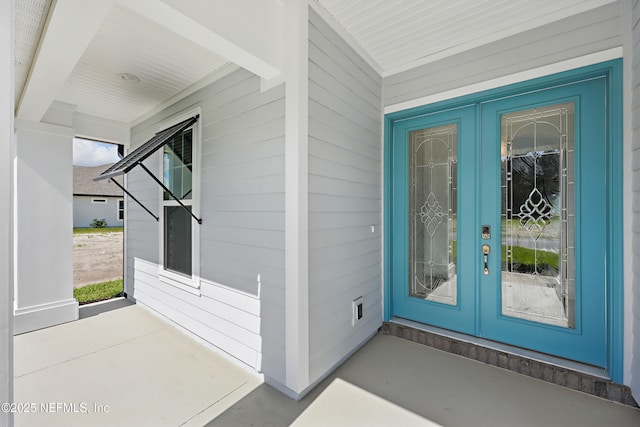 property entrance with a porch and french doors
