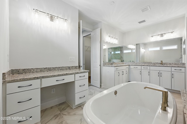 full bathroom with visible vents, a freestanding bath, marble finish floor, and vanity