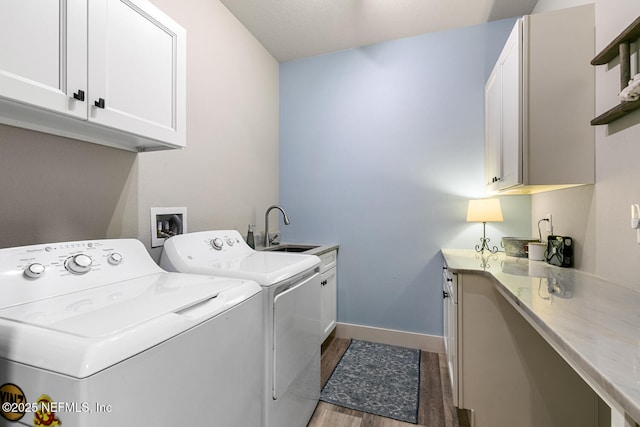 355 Lambert Ave, Flagler Beach, FL 32136 - washroom featuring baseboards, a sink, light wood-style floors, cabinet space, and washer and clothes dryer