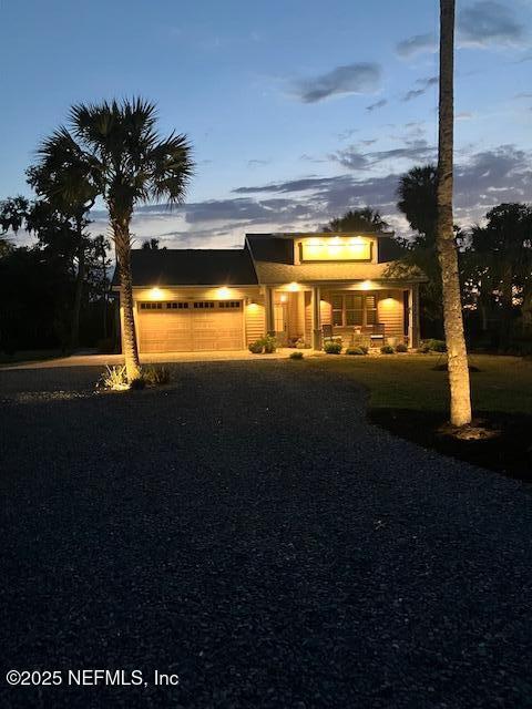 355 Lambert Ave, Flagler Beach, FL 32136 - view of front facade featuring an attached garage and aphalt driveway