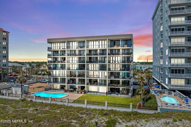 275 1st St S Unit 504, Jacksonville Beach, FL 32250 - property at dusk with fence