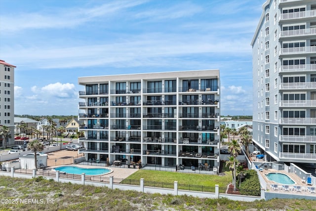 275 1st St S Unit 504, Jacksonville Beach, FL 32250 - view of apartment building / complex with fence and a community pool