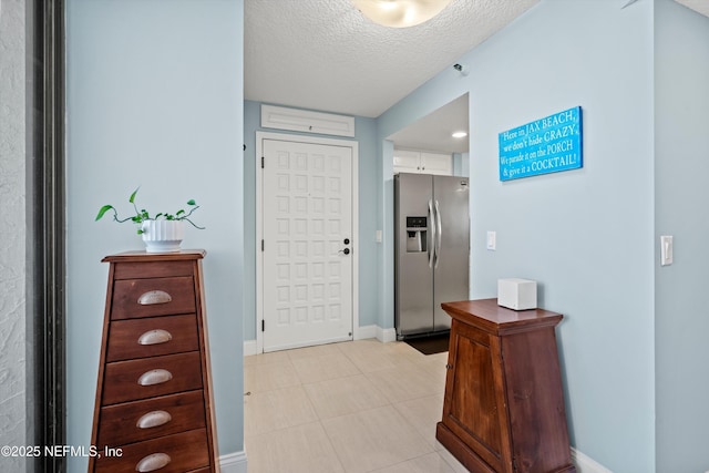 275 1st St S Unit 504, Jacksonville Beach, FL 32250 - foyer with a textured ceiling and baseboards