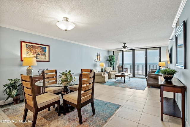 275 1st St S Unit 504, Jacksonville Beach, FL 32250 - dining space featuring a ceiling fan, a textured ceiling, ornamental molding, expansive windows, and a water view