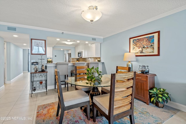 275 1st St S Unit 504, Jacksonville Beach, FL 32250 - dining room featuring crown molding, a textured ceiling, light tile patterned floors, and baseboards