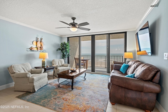 275 1st St S Unit 504, Jacksonville Beach, FL 32250 - living room featuring ceiling fan, ornamental molding, a textured ceiling, baseboards, and a water view