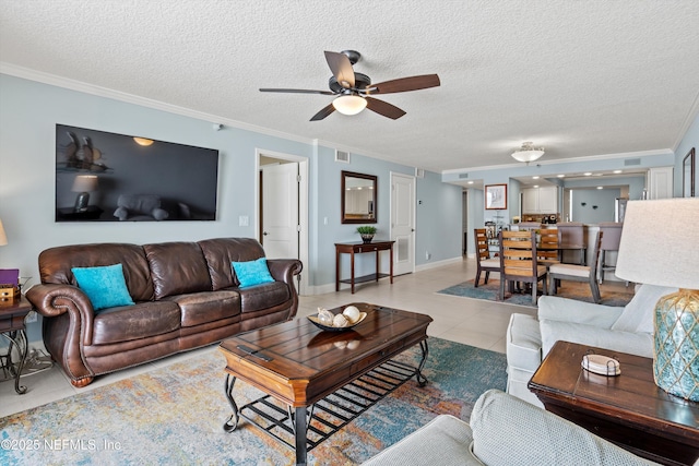 275 1st St S Unit 504, Jacksonville Beach, FL 32250 - living room with ornamental molding, a ceiling fan, a textured ceiling, baseboards, and light tile patterned floors
