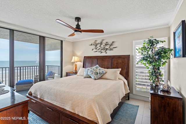 275 1st St S Unit 504, Jacksonville Beach, FL 32250 - bedroom with access to exterior, multiple windows, a water view, a textured ceiling, and ornamental molding