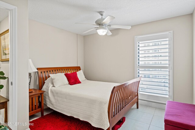 275 1st St S Unit 504, Jacksonville Beach, FL 32250 - bedroom with multiple windows, tile patterned flooring, and a ceiling fan
