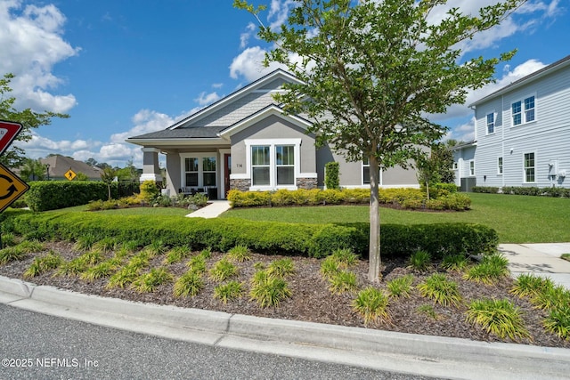 114 Fremont Ave, Saint Augustine, FL 32095 - view of front of property with central AC unit, stucco siding, stone siding, and a front lawn