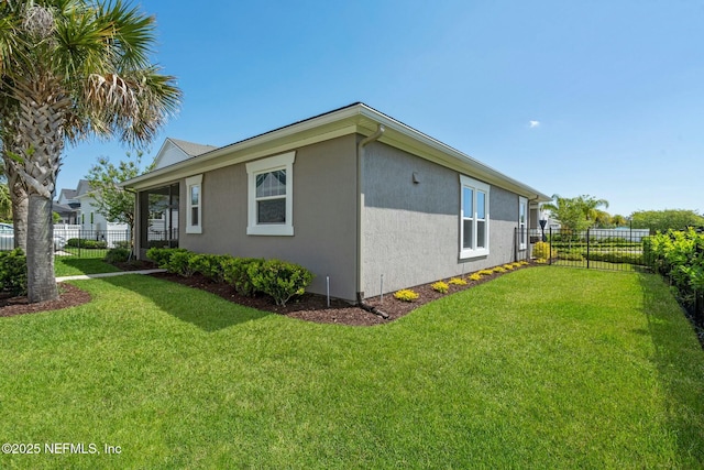114 Fremont Ave, Saint Augustine, FL 32095 - view of side of home with fence, a lawn, and stucco siding