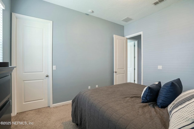 114 Fremont Ave, Saint Augustine, FL 32095 - bedroom featuring baseboards, visible vents, light colored carpet, and a textured ceiling