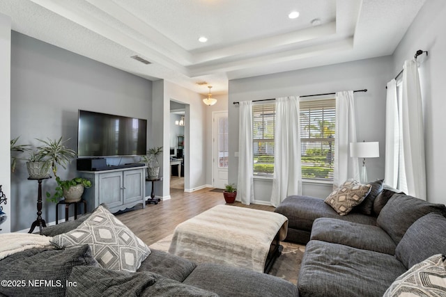 114 Fremont Ave, Saint Augustine, FL 32095 - living area featuring visible vents, baseboards, a tray ceiling, recessed lighting, and wood finished floors
