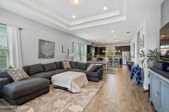 114 Fremont Ave, Saint Augustine, FL 32095 - living room featuring recessed lighting, a tray ceiling, and wood finished floors