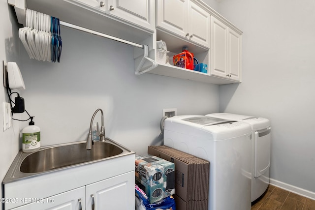 114 Fremont Ave, Saint Augustine, FL 32095 - washroom with separate washer and dryer, baseboards, dark wood-type flooring, cabinet space, and a sink