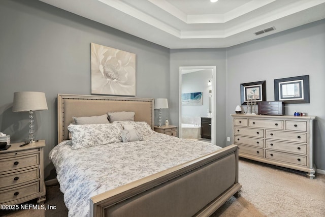 114 Fremont Ave, Saint Augustine, FL 32095 - carpeted bedroom featuring ensuite bath, visible vents, and a tray ceiling