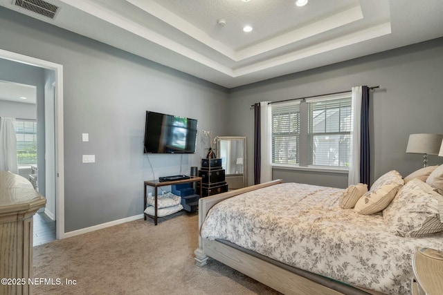 114 Fremont Ave, Saint Augustine, FL 32095 - carpeted bedroom featuring a tray ceiling, baseboards, visible vents, and recessed lighting