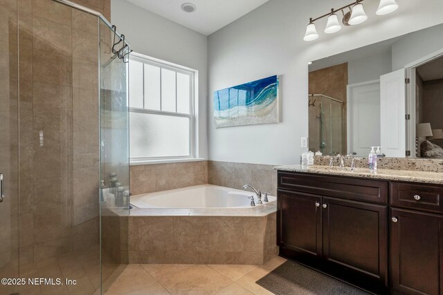 114 Fremont Ave, Saint Augustine, FL 32095 - bathroom featuring a shower stall, tile patterned floors, vanity, and a garden tub