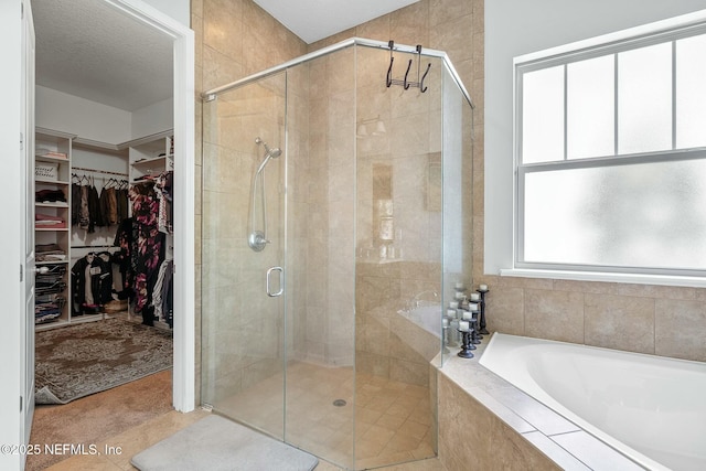 114 Fremont Ave, Saint Augustine, FL 32095 - full bath with a bath, a stall shower, a spacious closet, and a textured ceiling