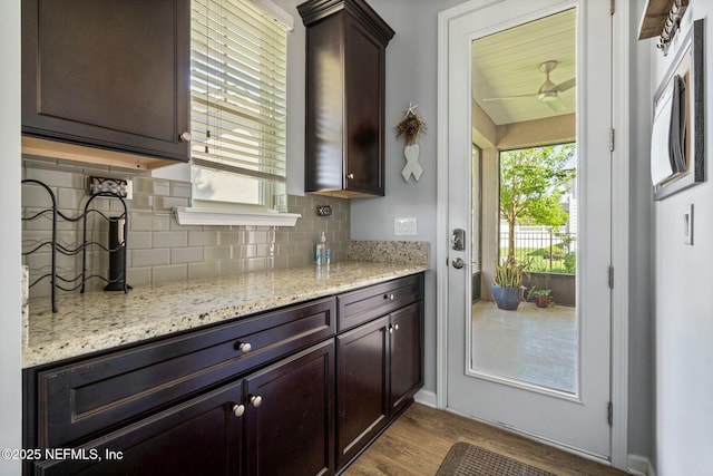 114 Fremont Ave, Saint Augustine, FL 32095 - kitchen featuring a healthy amount of sunlight, wood finished floors, dark brown cabinets, and backsplash