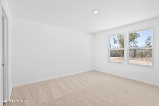 spare room with carpet flooring and baseboards