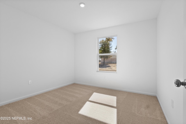 carpeted spare room with baseboards